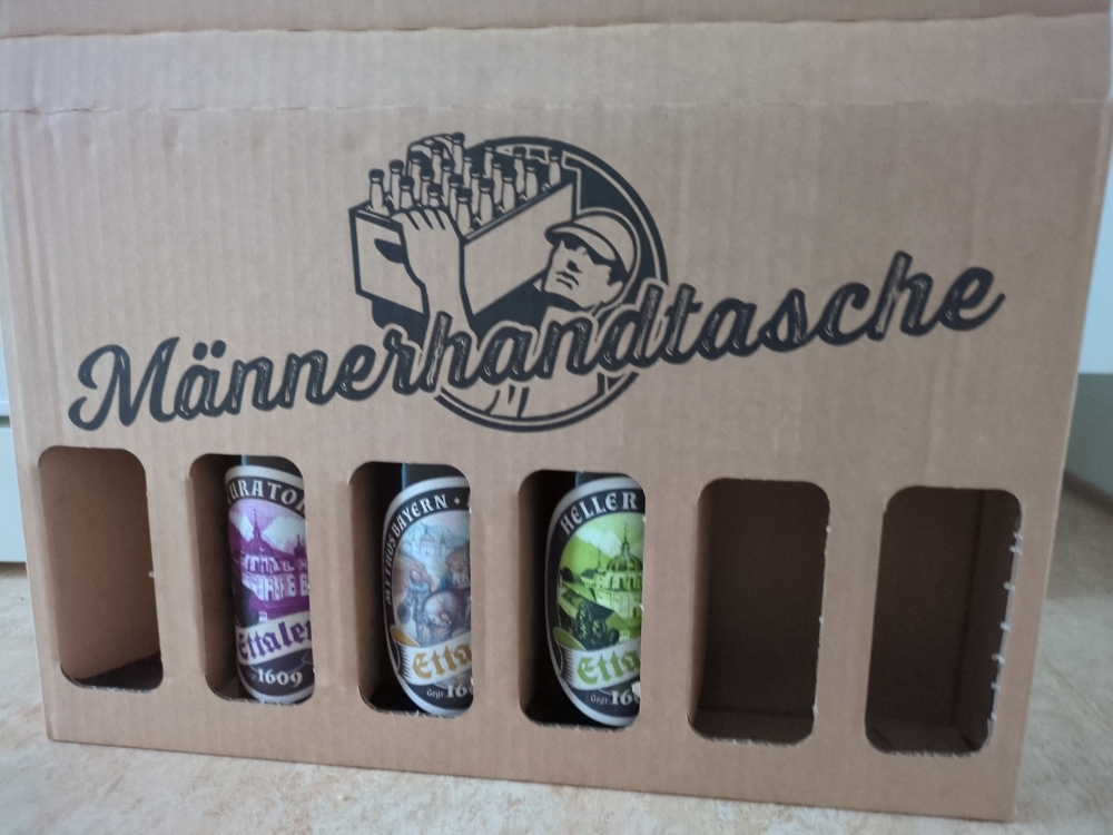 A cardboard bag with beer bottles.